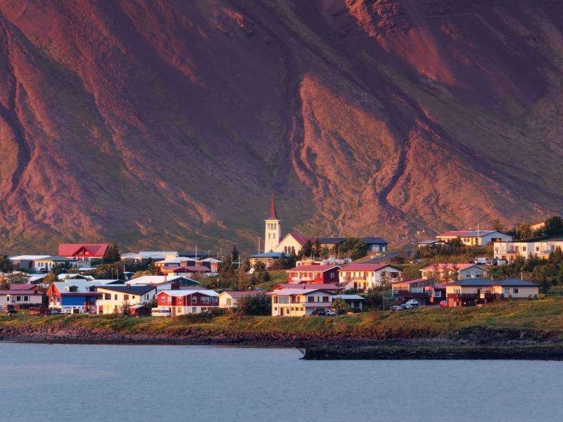 Sunset glowing on Icelandic village by coastline in Snaefellsnes Peninsula on summer at Iceland